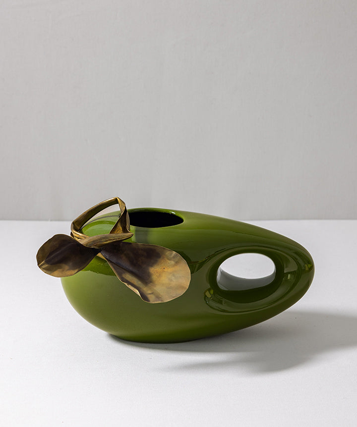 1960s Toyo biomorphic ceramic vase reimagined in martini olive. What was once a vintage brutalist belt buckle now blooms at the rim, proving great accessories aren’t limited to a wardrobe.