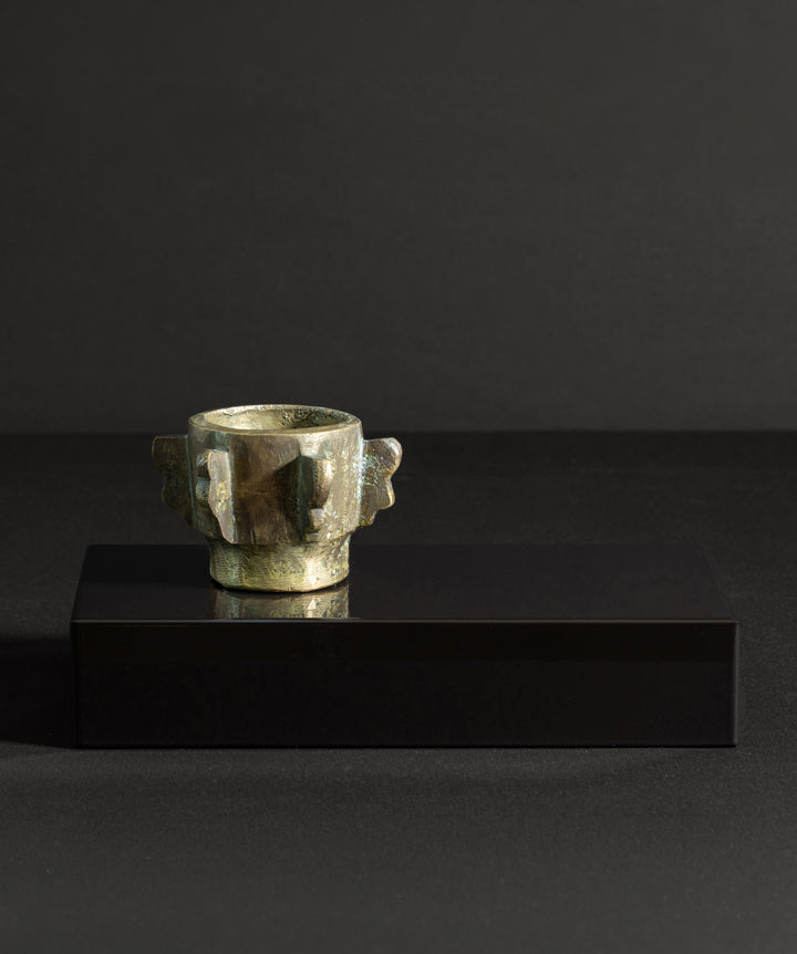 Cast iron bronze antique mortar placed on a solid marble base. The fixture tells of its past, while the base anchors it with a modern stance. Mortar remains unattached for personal placement.