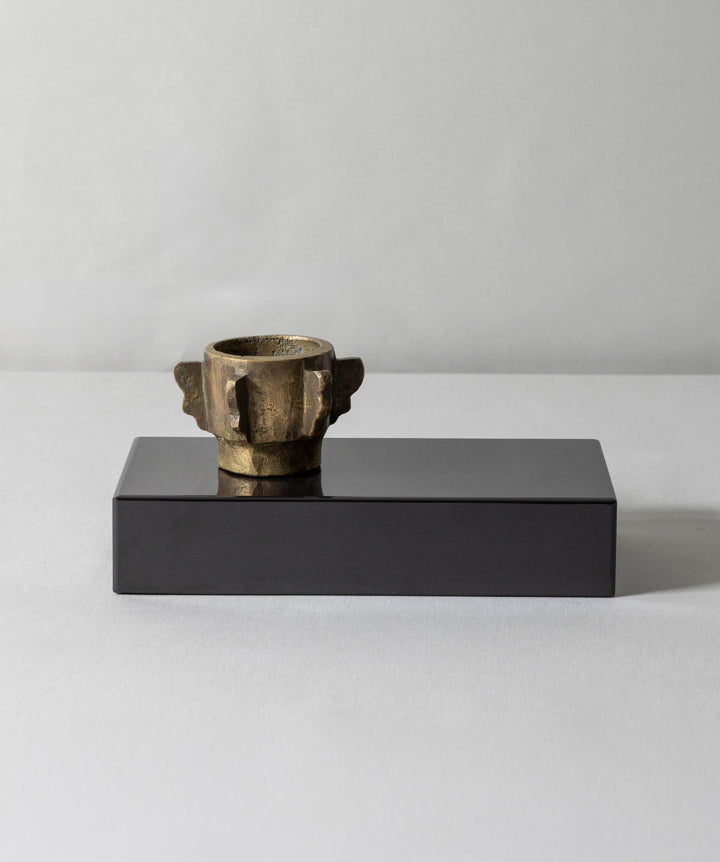 Cast iron bronze antique mortar placed on a solid marble base. The fixture tells of its past, while the base anchors it with a modern stance. Mortar remains unattached for personal placement.