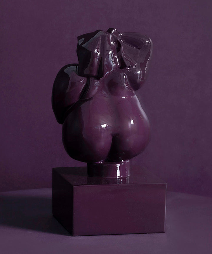 Zaftig Woman | Voluptuous bronze woman on solid marble coated in a custom high gloss urethane-based paint on a purple background.
