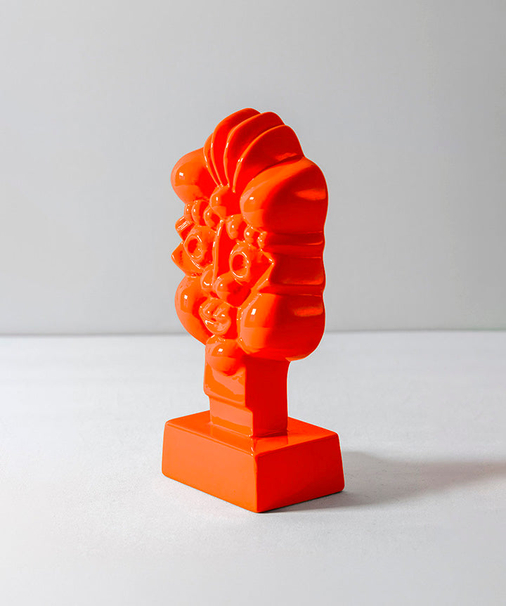 A modernist glass face full of animated expression. Heightened by a neon color, its presence appears even more vibrant in person. 
