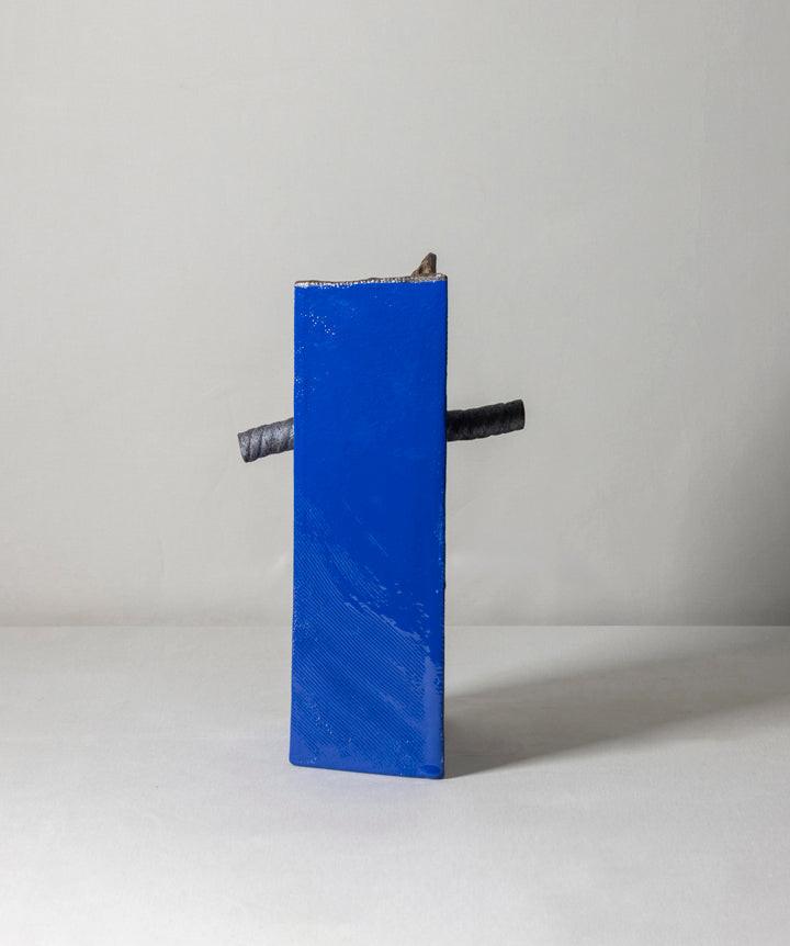 An edgy and truly unique vase made of ceramic drip glaze. The asymmetrical, textured exterior and smooth interior are separated by a removable ceramic pole running through its center.