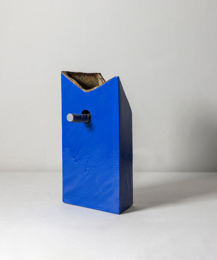 An edgy and truly unique vase made of ceramic drip glaze. The asymmetrical, textured exterior and smooth interior are separated by a removable ceramic pole running through its center.